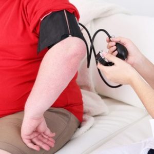 Doctor examining  patient obesity on light background